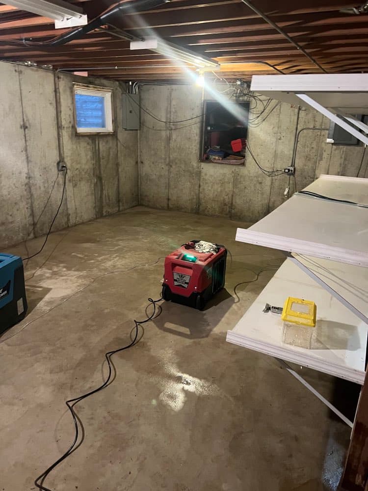 Dehumidifier drying an unfinished basement on a real job