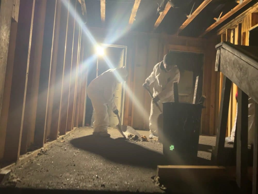 Flash crew in protective suits working a contaminated crawl space — a real job