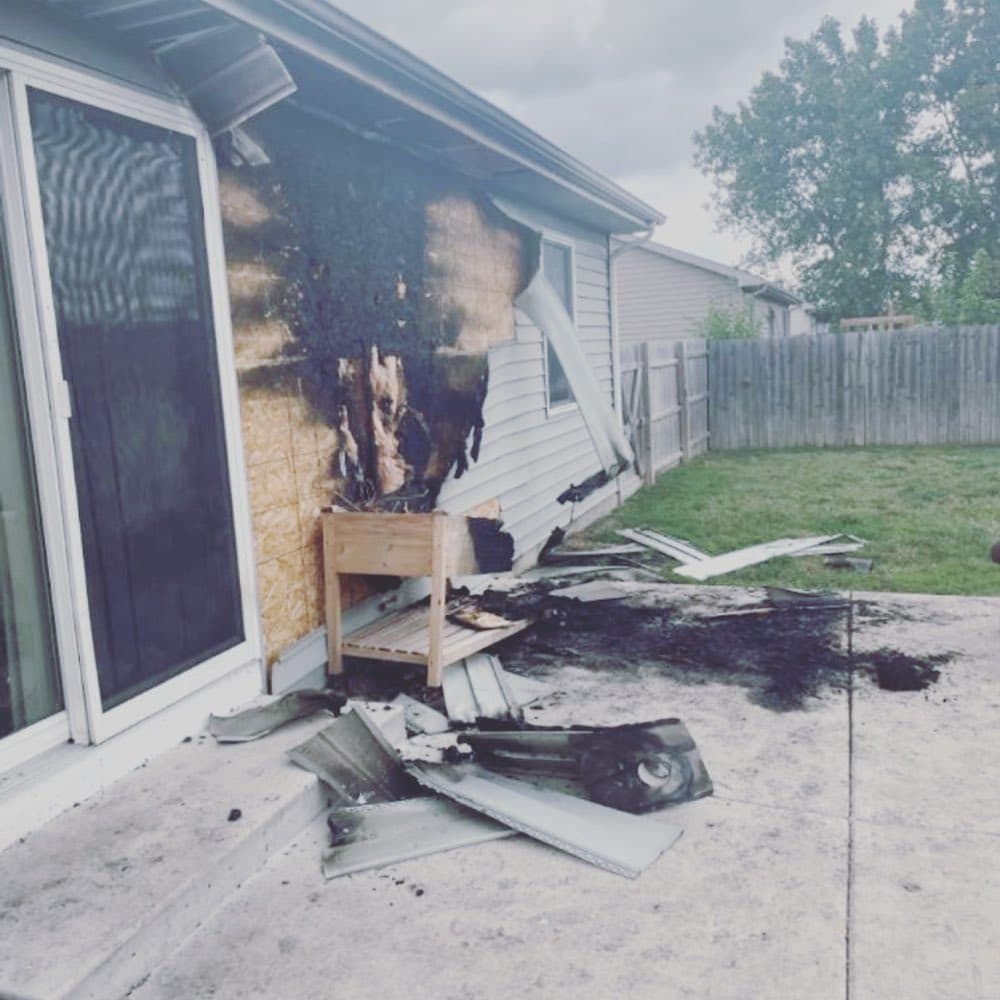 Fire-damaged home exterior before restoration