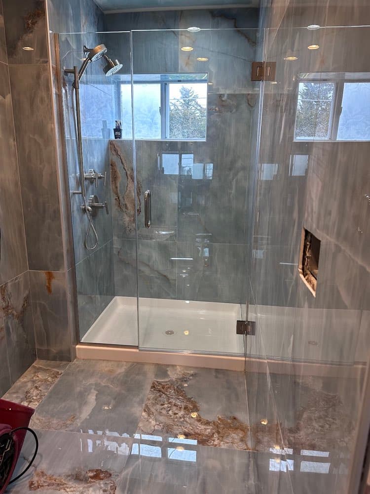Completed glass shower enclosure on a restoration rebuild
