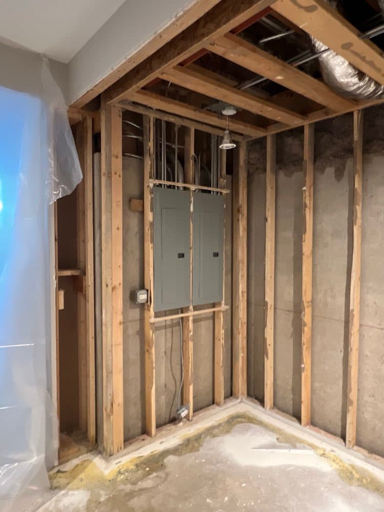 Wall opened to the studs after moisture damage, ready for treatment