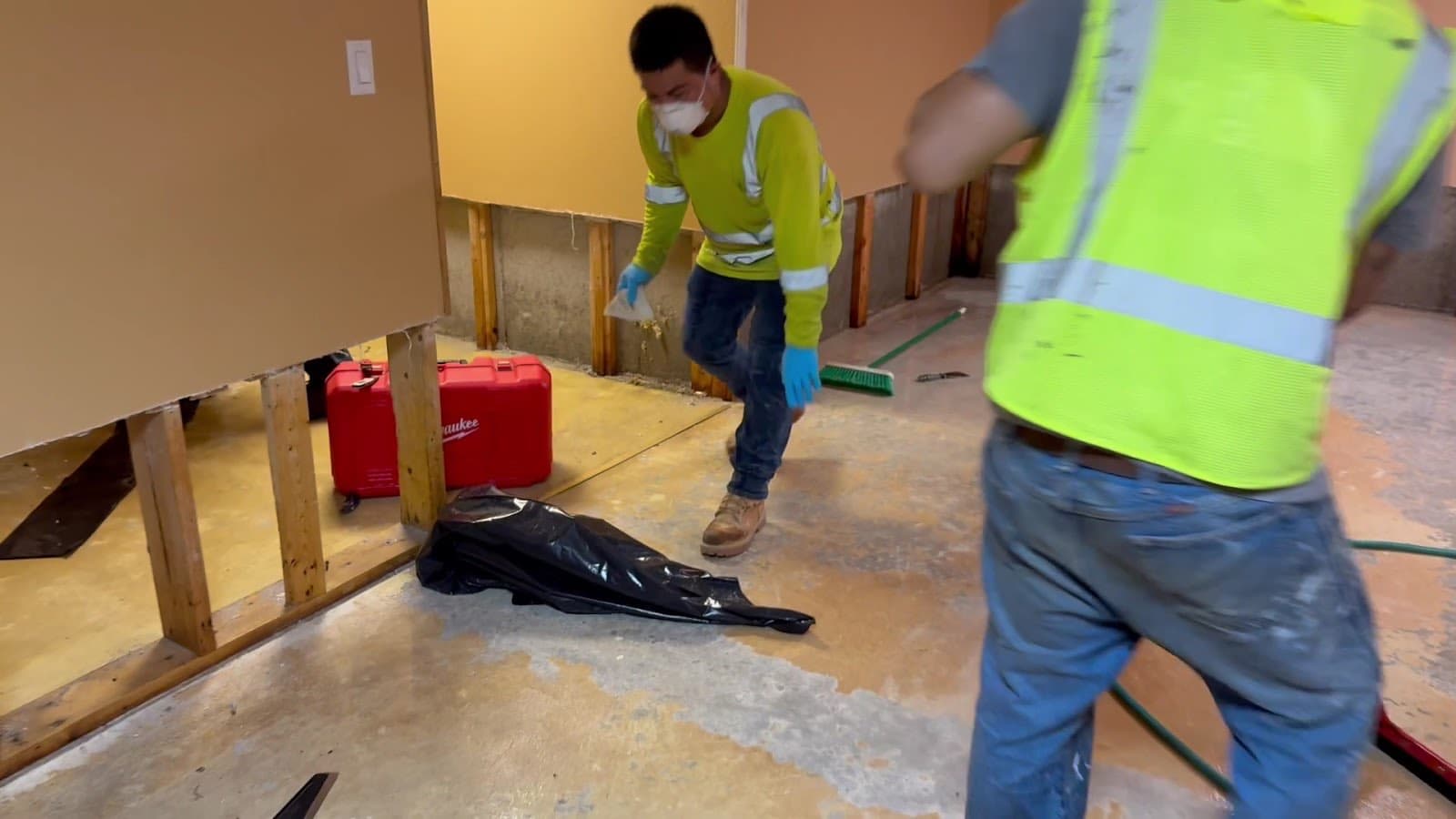 The Flash Restoration crew cutting water-damaged drywall on a real job