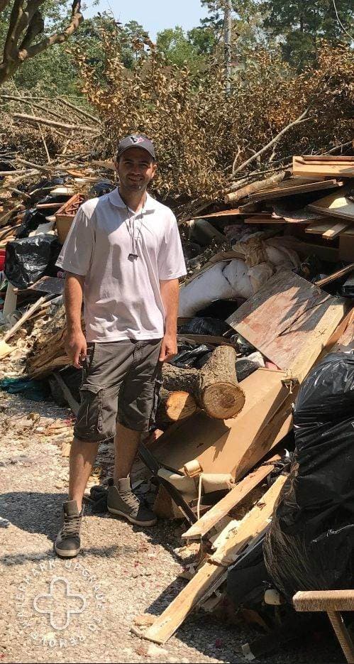A Flash crew member at a storm debris pile on a real response