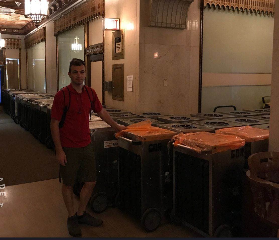 A Flash crew member with rows of drying equipment on a commercial job