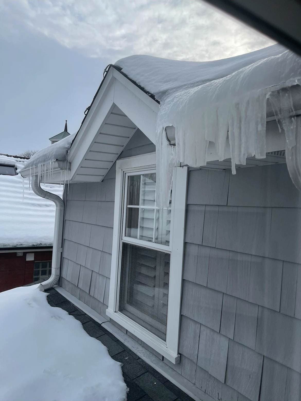 Icicles loading the roof edge before steaming